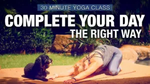 Class thumbnail: Complete Your Day the Right Way, 30 minute class, woman in child's pose with a small dog