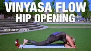 Class thumbnail: Vinyasa Flow Hip Opening, woman folded on a mat on grass, filmed in Colorado