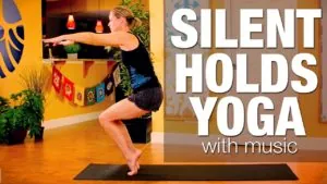Class thumbnail: Silent Holds Yoga with music, woman in a standing balance in a colorful room