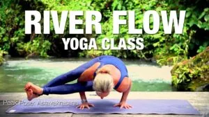 Class thumbnail: River Flow Yoga Class, woman in an arm balance on a mat by a river