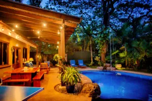 Casa Colorado patio and pool lit at night with a ping pong table