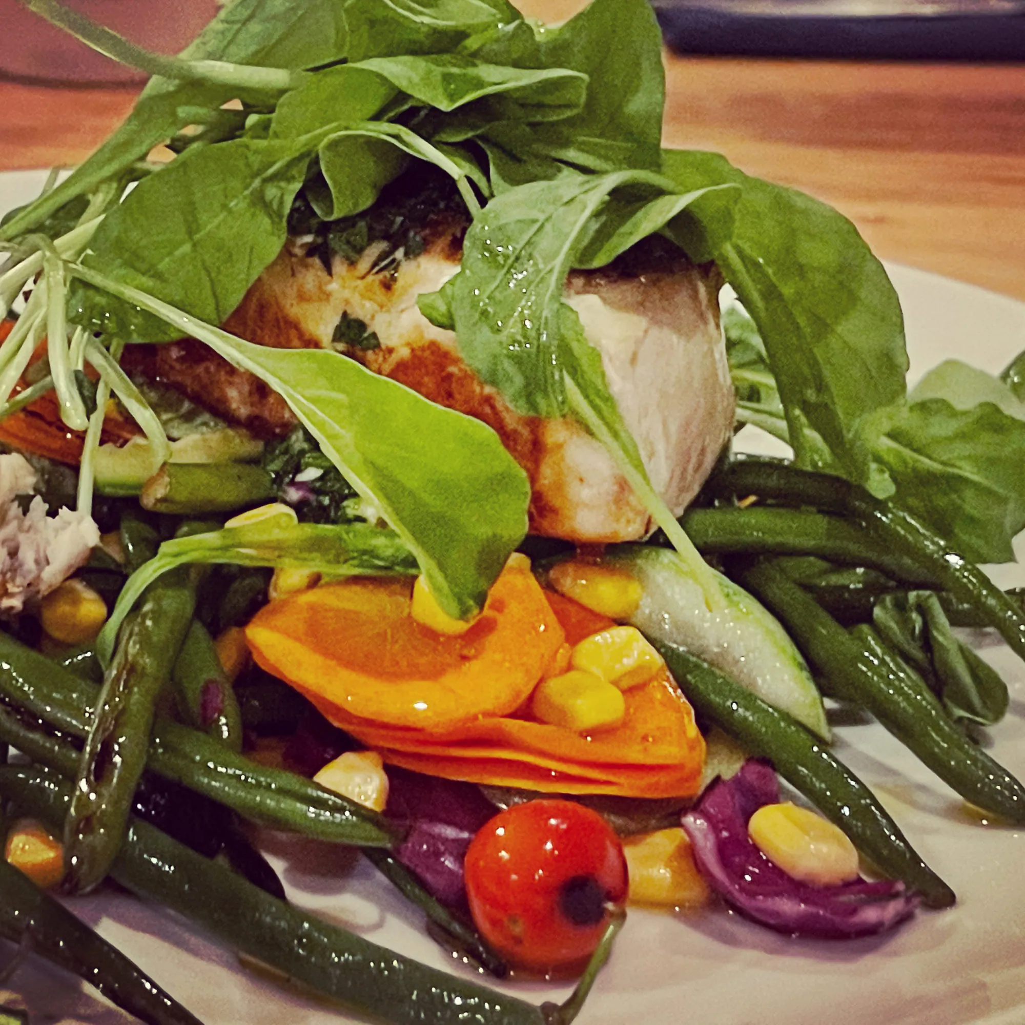 Retreat dinner of seared fish with arugula, green beans and roasted vegetables
