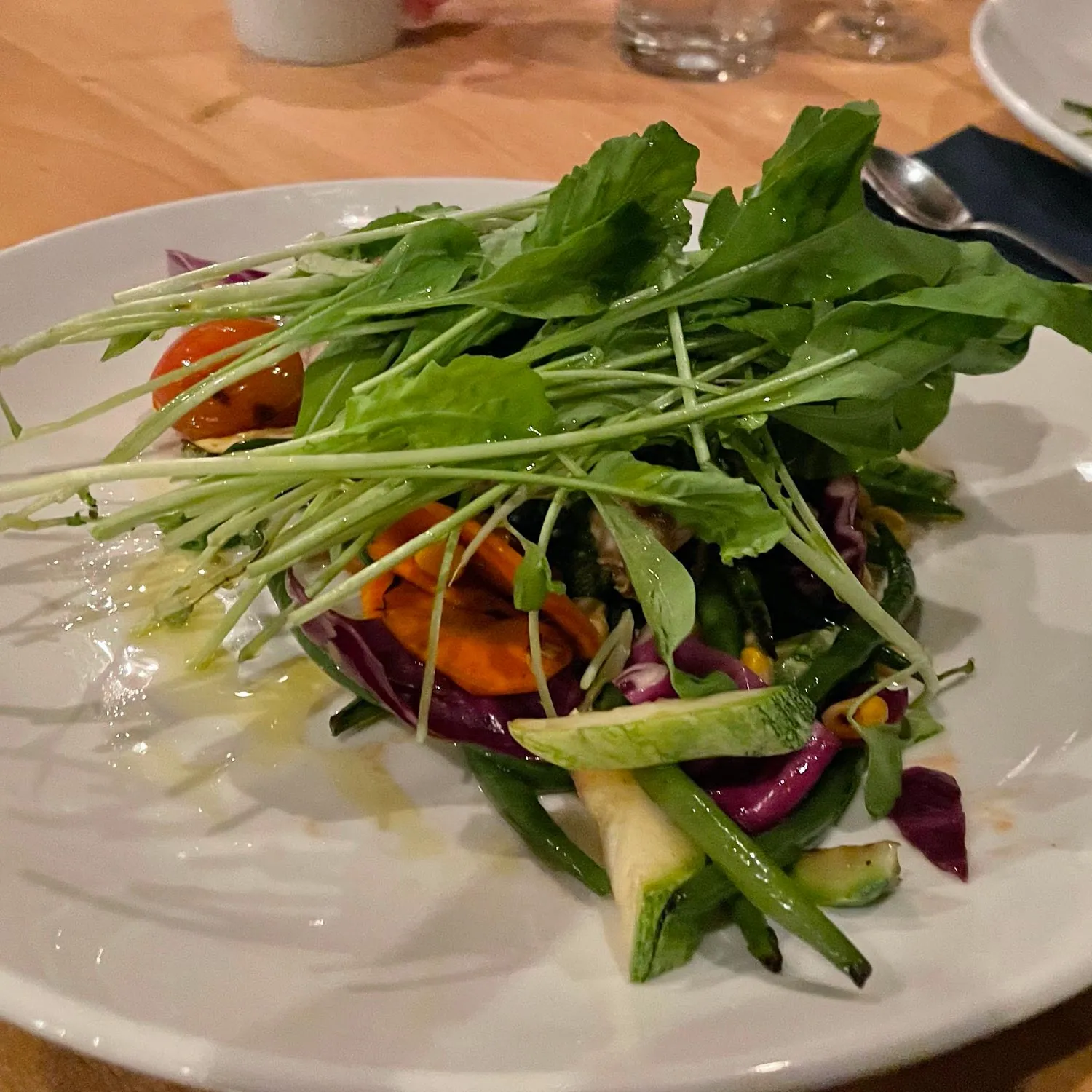 Fresh salad with greens on a white plate
