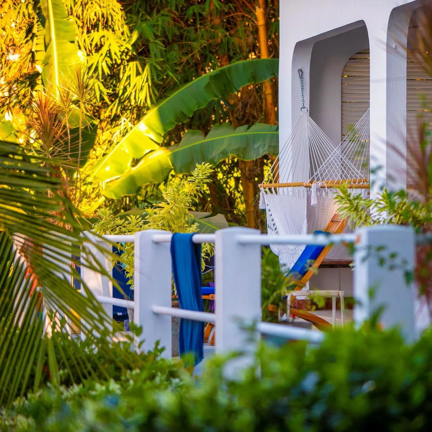 Balcony with a hammock, lounge chair and drying towel among tropical plants at Casas Kismet, Nosara