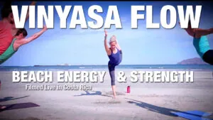 Class thumbnail: Vinyasa Flow Beach Energy and Strength, woman in a standing split on a beach