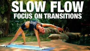 Slow Flow focus on transitions yoga class, woman in a wild thing pose on a mat