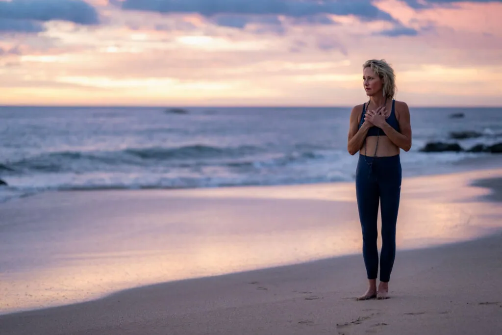 Erin Sampson practicing yoga on the beach