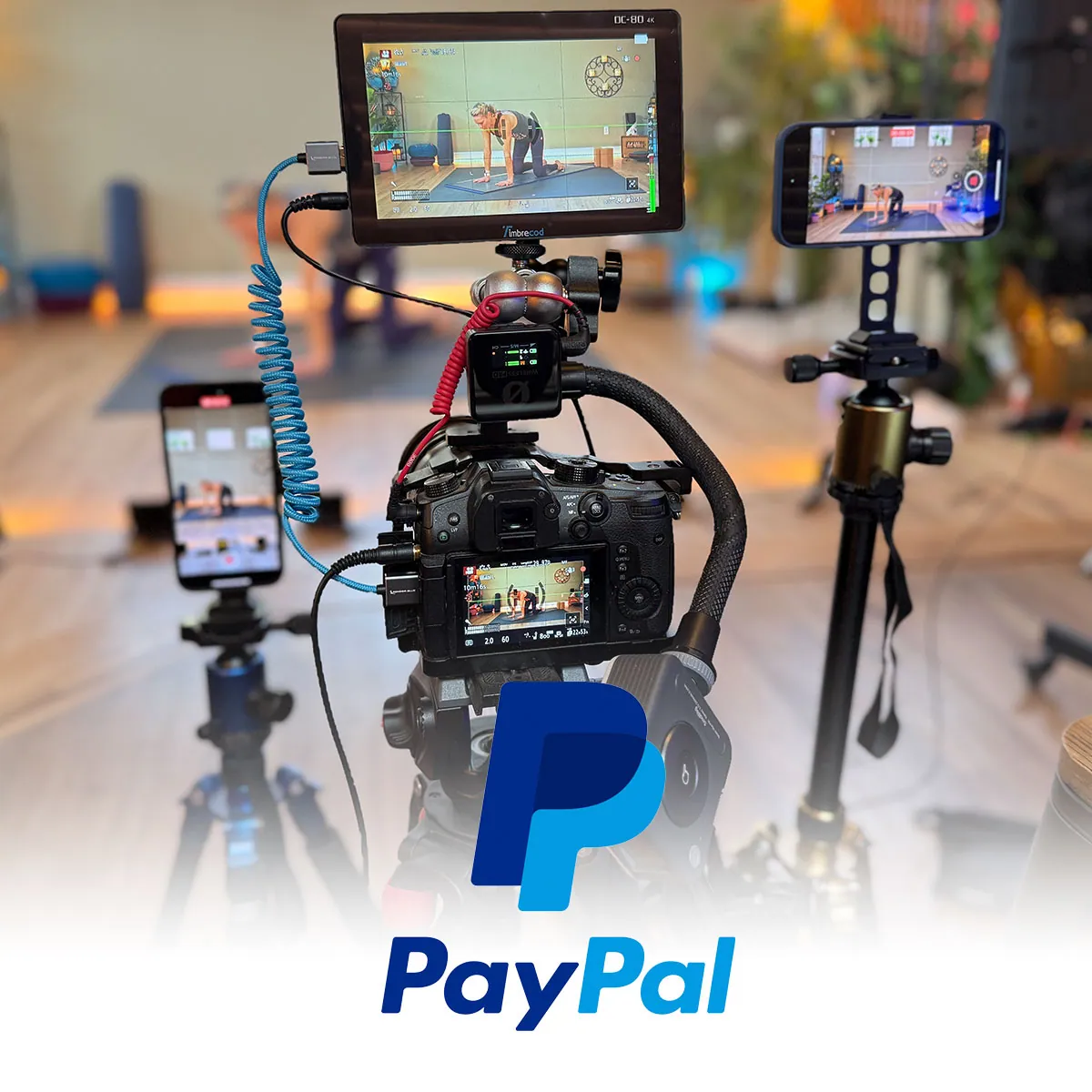 Camera rig and monitors in a yoga studio with PayPal logo