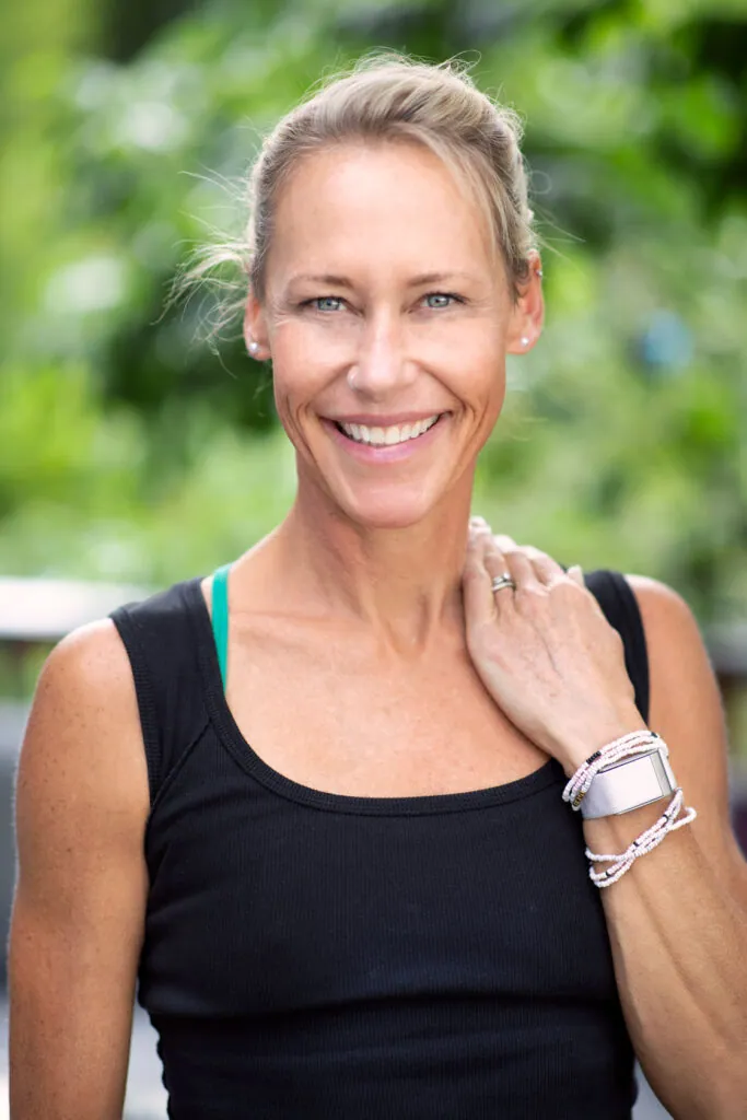 Erin Sampson smiling outdoors in a black tank top